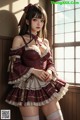 A woman in a maid outfit posing in front of a window.