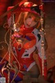 A woman in a red and white outfit sitting on a swing.